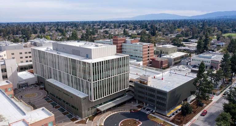 Image of Sobrato office building, taken from the air, showing the building, it's parking garage adjacent to the south